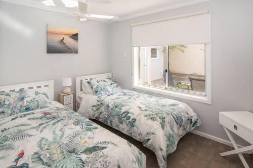 a bedroom with two beds and a window at Jetty Views -100m to foreshore in Busselton