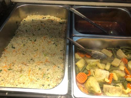 two metal trays of food with rice and vegetables at e34 Café, Restaurant & Hotel Koslanda Hideaway with a Private Natural Pool in Koslanda