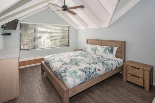 a bedroom with a bed and a ceiling fan at Sea Breeze Villa in Dunsborough