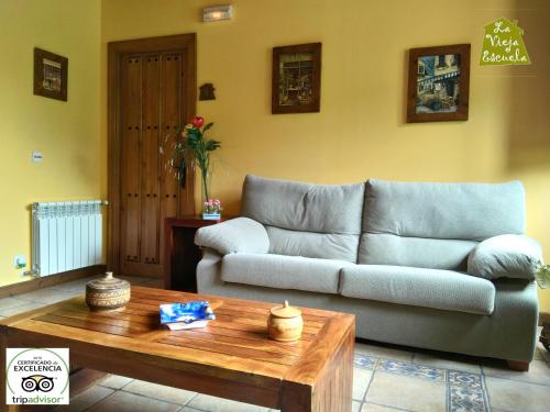 a living room with a couch and a coffee table at Posada La Vieja Escuela in San Roque de Ríomiera