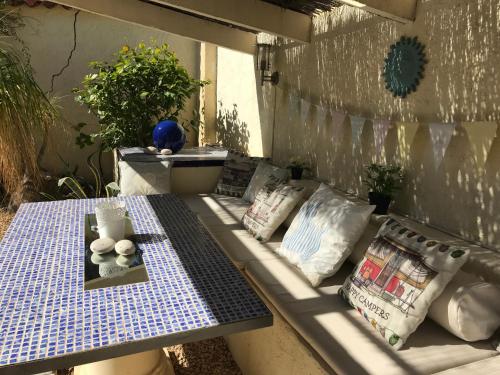 a bench with pillows and a table on a patio at Casa Oasis in Albir