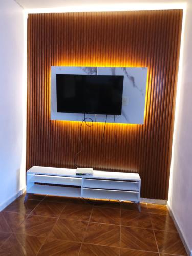a living room with a flat screen tv on a wall at Residence Tropical Garden in Boca Chica