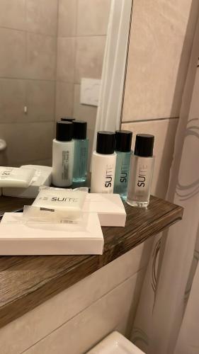 a group of three bottles on a shelf in a bathroom at Wake&Relax in Decollatura