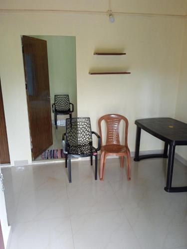 a room with chairs and a table and a table at Homestay valakode in Idukki