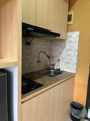 a kitchen with a sink and a stove at instaspace in Bandung