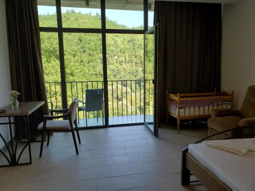 a living room with a view of a balcony at The Whispering Oaks Retreat in Vahagnadzor