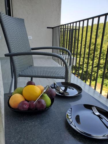 a bowl of fruit on a table with a chair at The Whispering Oaks Retreat in Vahagnadzor