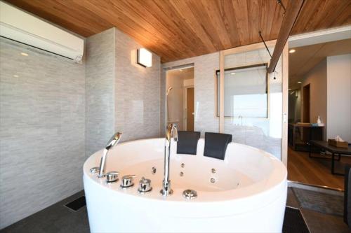 a large white bath tub in a room at BU1 瀬々串 海テラスSesekushi Umi terrace in Kagoshima