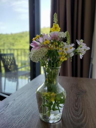 a vase filled with flowers sitting on a table at The Whispering Oaks Retreat in Vahagnadzor