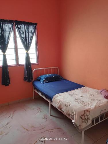 a bedroom with a bed and two windows at Homestay Bait Al-Sakinah in Simpang Ampat