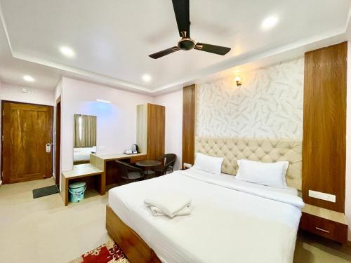 a bedroom with a bed with a ceiling fan at SEA VIEW - LUXURY HOTEL NB RESORT ! PURi in Puri