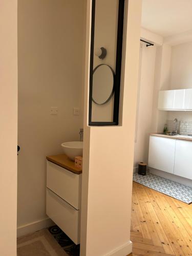 a bathroom with a sink and a mirror at Chambre toute équipée in Lisieux