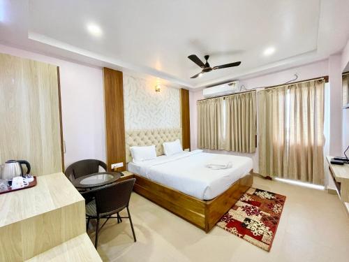 a bedroom with a bed and a desk and a chair at SEA VIEW - LUXURY HOTEL NB RESORT ! PURi in Puri