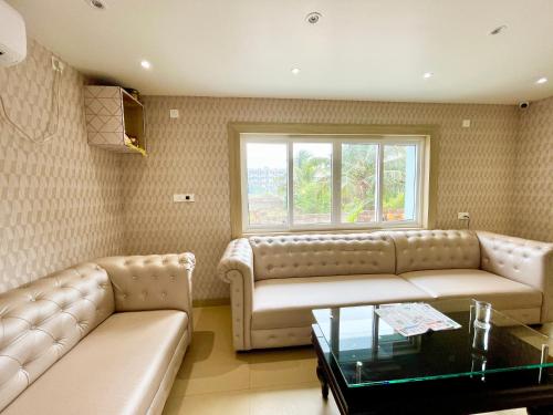 a living room with a couch and a coffee table at SEA VIEW - LUXURY HOTEL NB RESORT ! PURi in Puri