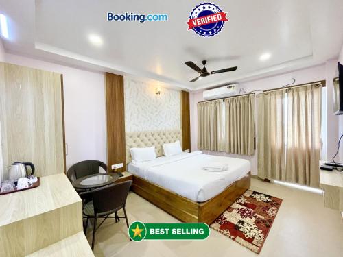 a hotel room with a bed and a desk at SEA VIEW - LUXURY HOTEL NB RESORT ! PURi in Puri
