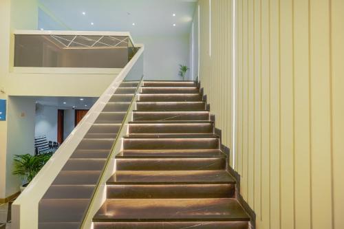 a staircase in a building with brown steps at Hotel Comfort Court in Amritsar