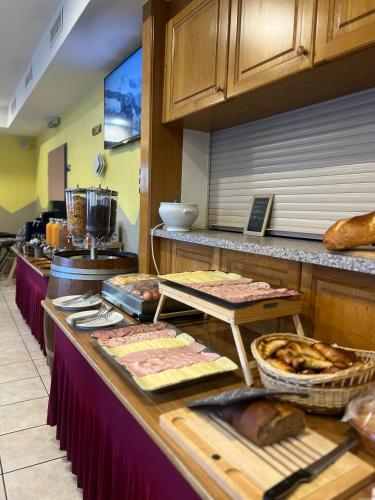 a kitchen with a counter with some food on it at Touristenheim Bergfreude in Leukerbad
