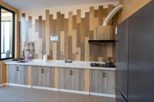 a kitchen with a sink and a counter top at Zuolin Youli Xiaoying Exclusive Courtyard in Huairou