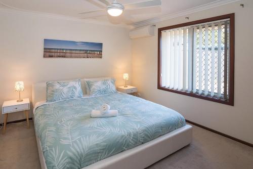 a bedroom with a bed with a toy on it at A Shore Thing- Located opposite Busselton Foreshore! in Busselton