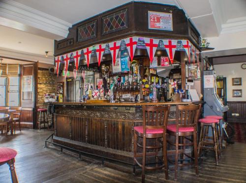 a bar with a lot of bottles of alcohol at The Royal Oak Hotel in Helmsley