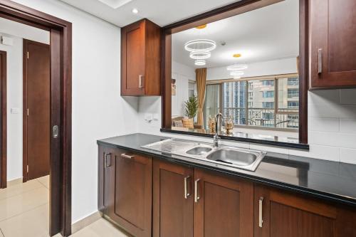 a kitchen with a sink and a large mirror at White House With Burj Views, Free Parking in Dubai