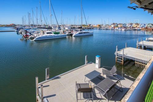 a dock with boats docked in a marina at Waters Edge- Kayaks, private jetty, WIFI in Geographe