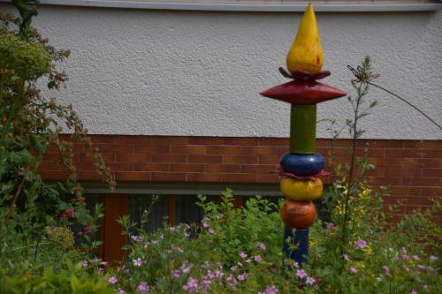 a colorful bird feeder in a garden at Gasthaus-Pension Hofmann in Oberdachstetten