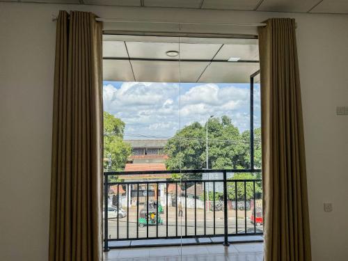 a room with a window with a view of a building at Gondolas Hotel Stay in Ragama