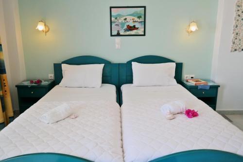 two beds with stuffed animals on them in a room at Maroussa Studios in Agia Anna Naxos