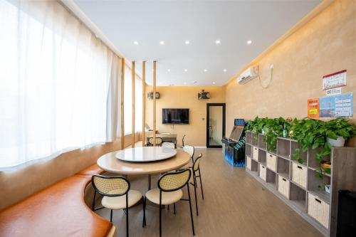 a room with a table and chairs and a plant at Zuolin Youli Xiaoying Exclusive Courtyard in Huairou