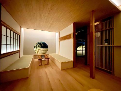 a room with a couch and a vase on the wall at Nagomi in Dazaifu