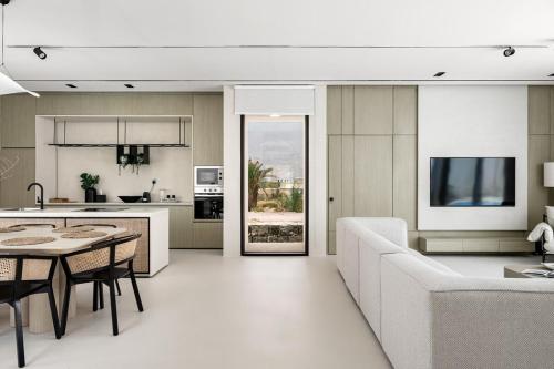 a kitchen and living room with a couch and a table at Alrams Retreat in Ras al Khaimah