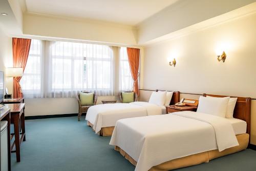 Ένα ή περισσότερα κρεβάτια σε δωμάτιο στο East Coast Hotel