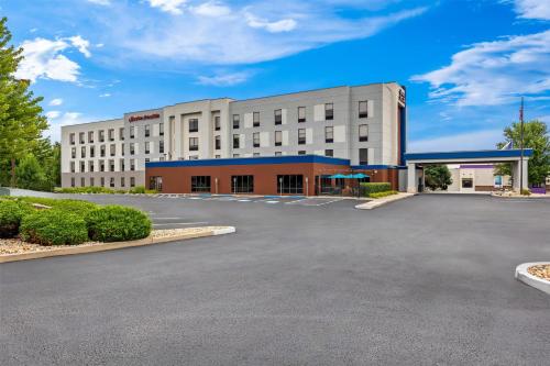 a large white building with a parking lot at Hampton Inn & Suites Grove City in Grove City