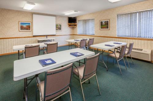 a classroom with tables and chairs and a whiteboard at Baymont by Wyndham Midland in Midland