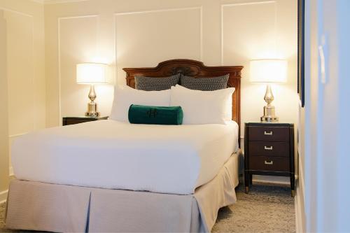 a bedroom with a large white bed with two night stands at The Oxford Hotel in Denver