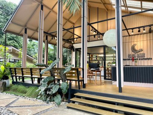 a patio with benches and a table on a building at Lalalune Khao Sok Resort & Lifestyle in Khao Sok