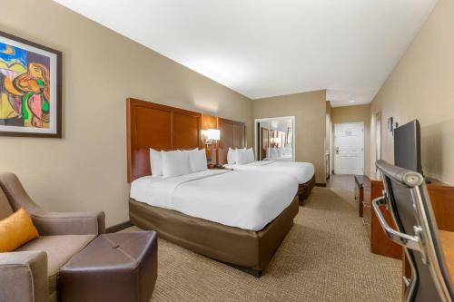 a hotel room with two beds and a couch at Comfort Inn Memphis Downtown in Memphis