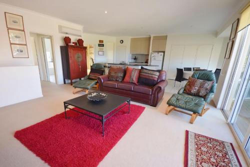 a living room with couches and a red rug at Sandpiper 8 - Close to Town and Beach in Inverloch