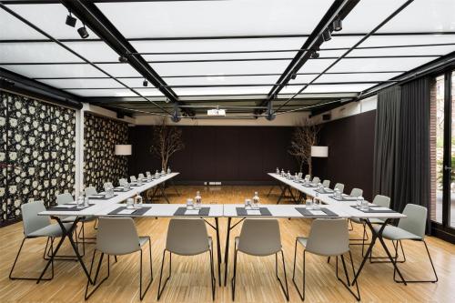 a large conference room with a long table and chairs at Alexandra Barcelona Hotel, Curio Collection by Hilton in Barcelona