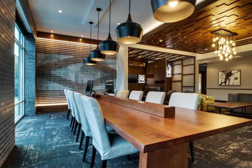 a conference room with a long wooden table and chairs at Hyatt Place Milwaukee Downtown in Milwaukee