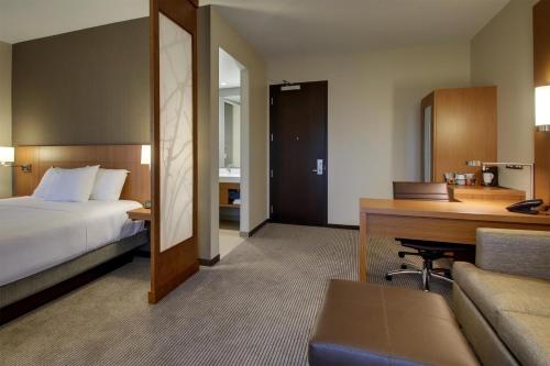 a hotel room with a bed and a desk at Hyatt Place Milwaukee Downtown in Milwaukee