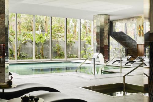 a swimming pool in a house with windows at Grand Hyatt Barcelona in Barcelona