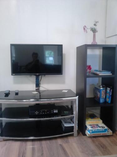 a flat screen tv sitting on top of a entertainment center at Canora Vacation Home in Canora