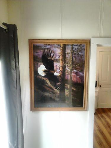 a painting of an eagle hanging on a wall at Canora Vacation Home in Canora