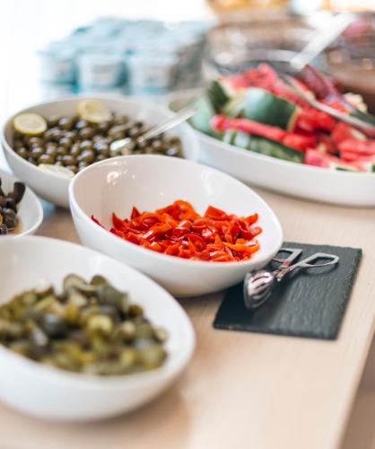 a table topped with bowls of different types of vegetables at Delight Hotel in Ksamil