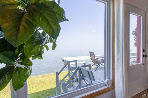 a view from a window of a table and chairs at Waterfront - Incredible- Le Deriveur in Saint-Antoine-Lotbinière