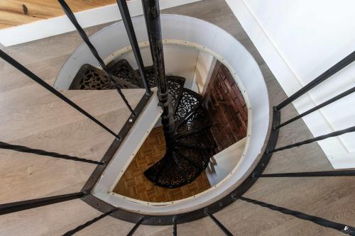 a spiral staircase in a building with a spiral at Waterfront - Incredible- Le Deriveur in Saint-Antoine-Lotbinière