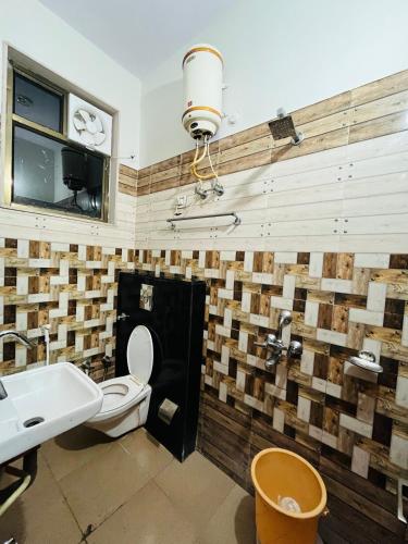 a bathroom with a toilet and a sink at Hotel & Resort Virasat inn in Alwar