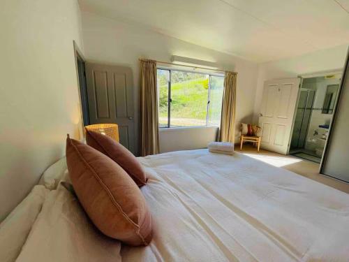 a bedroom with a large bed with pillows on it at Rural retreat! 5 min to wineries & 10 min to town in Bethany